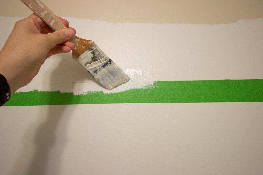 How do you paint a straight line on a wall with tape